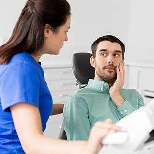 man in green shirt in pain